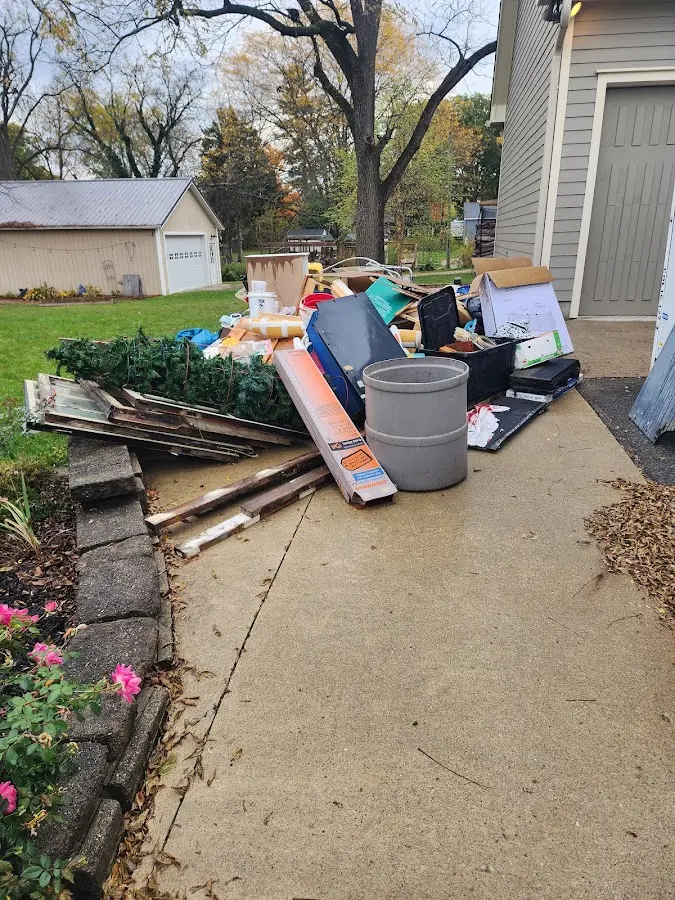 Dumpster being loaded with debris for Roofing Dumpster Rental in Spanish Springs